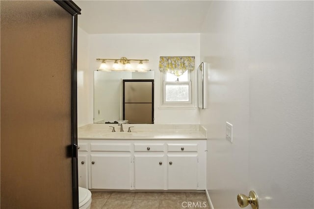 bathroom featuring vanity, toilet, and tile patterned floors