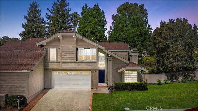 view of front of home featuring driveway, a front yard, and fence