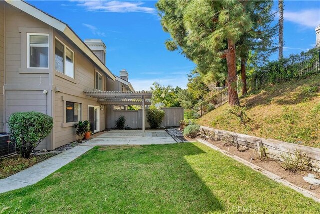 view of yard with a patio area, a fenced backyard, and a pergola