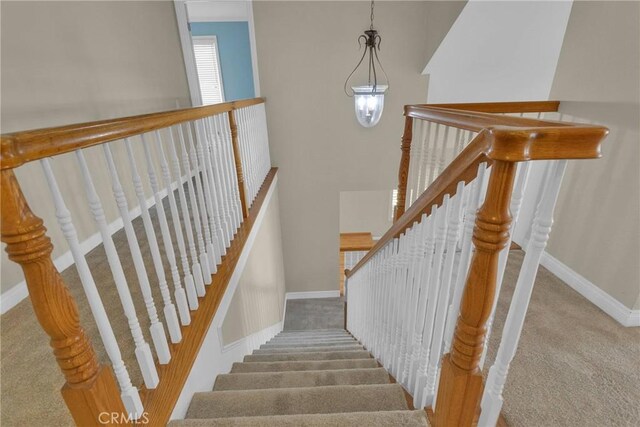 stairs with carpet and baseboards