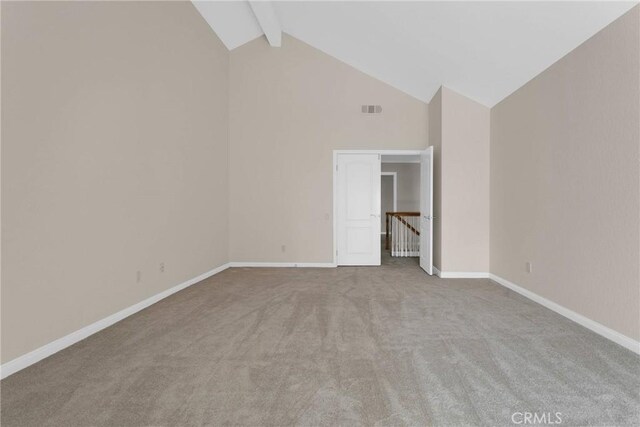 unfurnished bedroom with high vaulted ceiling, light colored carpet, visible vents, baseboards, and beam ceiling