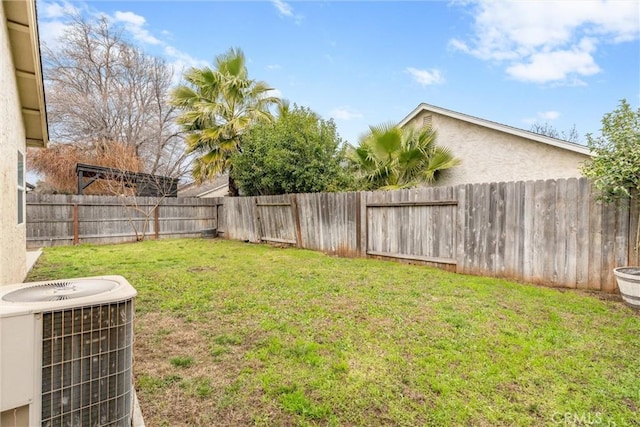 view of yard featuring a fenced backyard and central AC unit