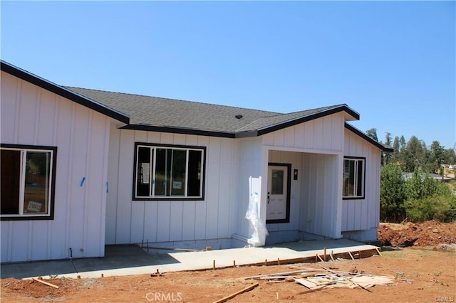 view of front of property with board and batten siding and roof with shingles