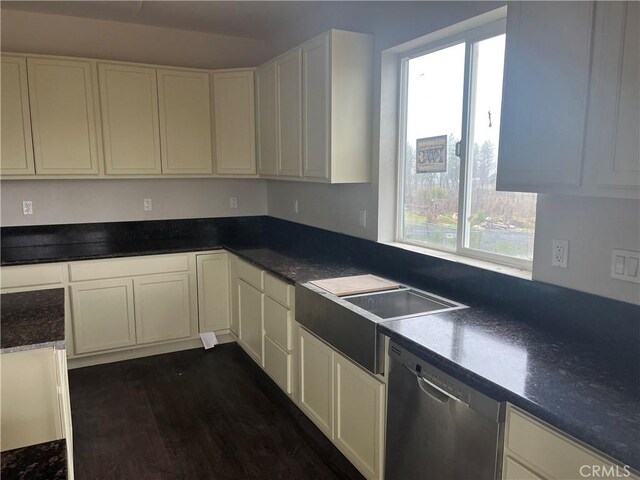 kitchen with dark countertops, white cabinetry, and stainless steel dishwasher