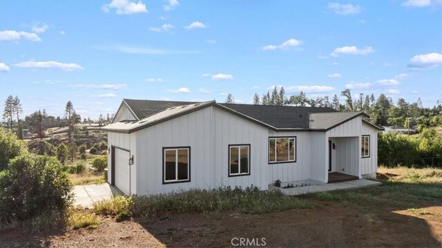 5627 Newland Rd, Paradise, CA 95969 - view of front of home featuring driveway, a garage, and board and batten siding