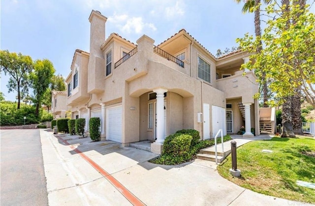 view of front of home featuring stucco siding, driveway, and a chimney