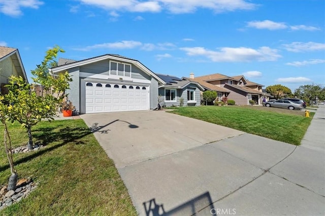 view of front of property featuring concrete driveway, an attached garage, a front yard, roof mounted solar panels, and a residential view