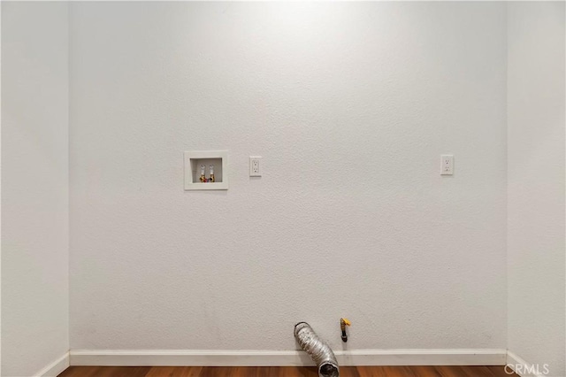 laundry room with laundry area, wood finished floors, baseboards, and washer hookup