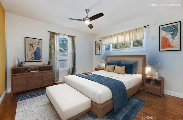 bedroom with ceiling fan, baseboards, and wood finished floors