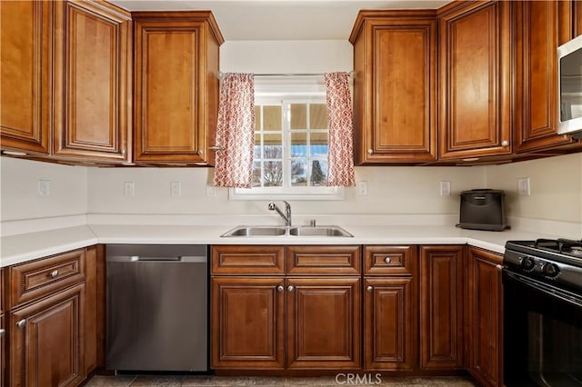 kitchen with a sink, stainless steel appliances, brown cabinetry, and light countertops