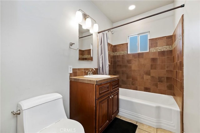 full bath featuring vanity, tile patterned floors, toilet, and shower / bath combo with shower curtain