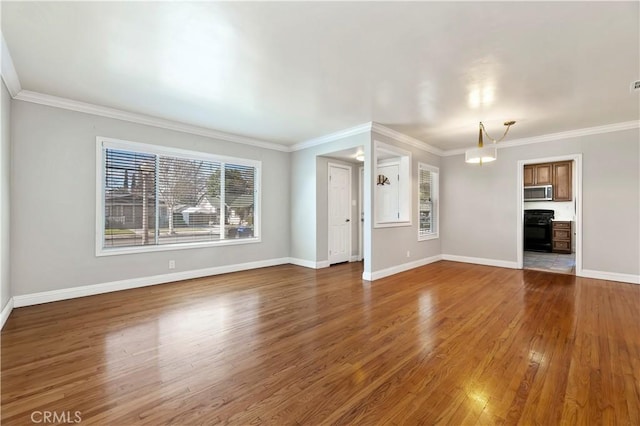 unfurnished living room featuring wood finished floors, baseboards, and ornamental molding