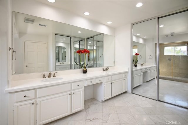 bathroom with double vanity, a sink, visible vents, and recessed lighting