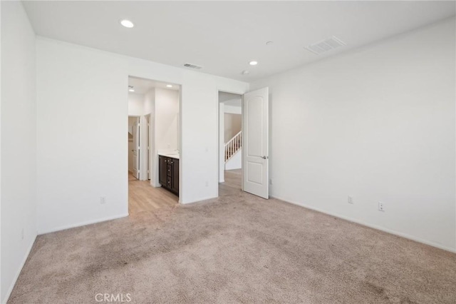 unfurnished bedroom with recessed lighting, visible vents, and light colored carpet