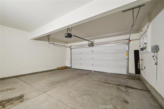 garage featuring baseboards and a garage door opener