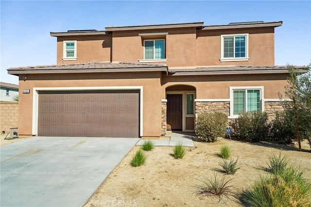 view of front of house featuring stone siding, driveway, an attached garage, and stucco siding