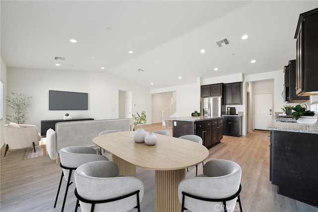 dining space featuring lofted ceiling, recessed lighting, visible vents, and light wood-style floors