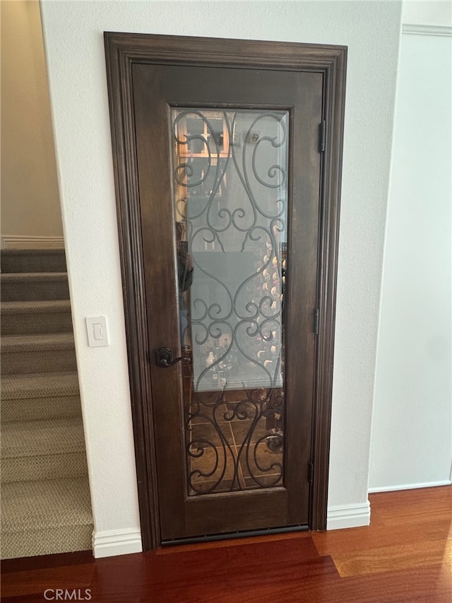 room details featuring baseboards and wood finished floors