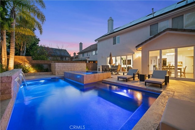 view of pool featuring an in ground hot tub, a patio, and a fenced backyard