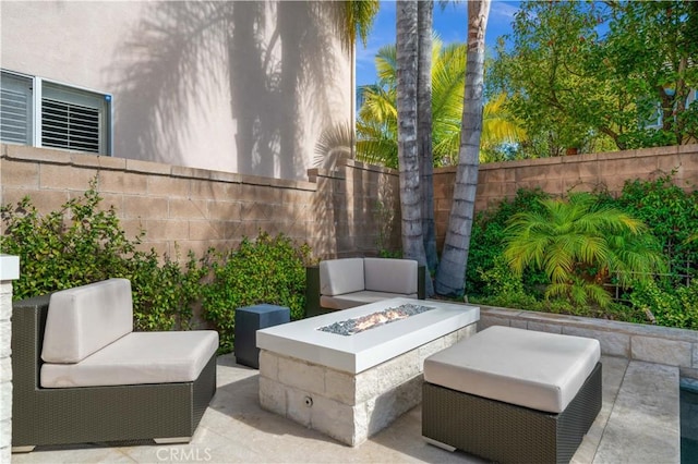 view of patio with an outdoor fire pit and fence