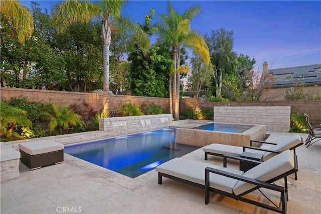 view of swimming pool featuring an in ground hot tub, a patio area, a fenced backyard, and a fenced in pool