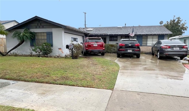 ranch-style home featuring driveway and a front yard