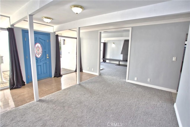 below grade area featuring carpet floors and baseboards