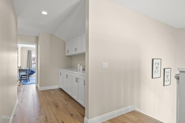 interior space featuring vaulted ceiling, recessed lighting, light wood-type flooring, and baseboards