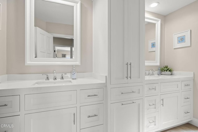 full bath featuring double vanity and a sink