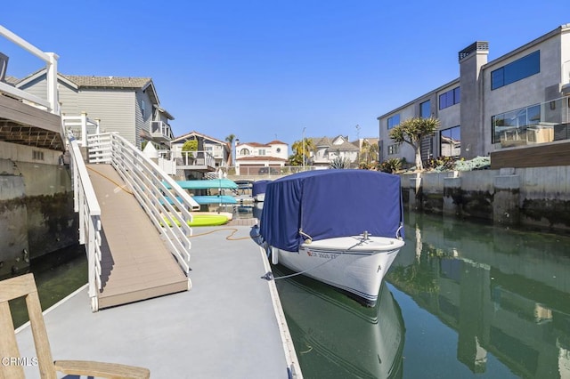 dock area featuring a water view and a residential view