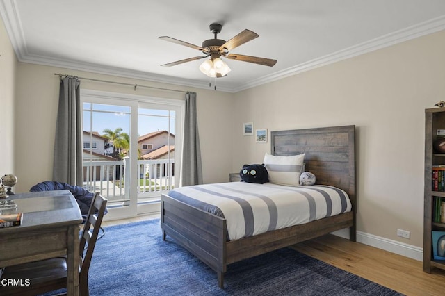 bedroom with wood finished floors, a ceiling fan, baseboards, access to outside, and crown molding