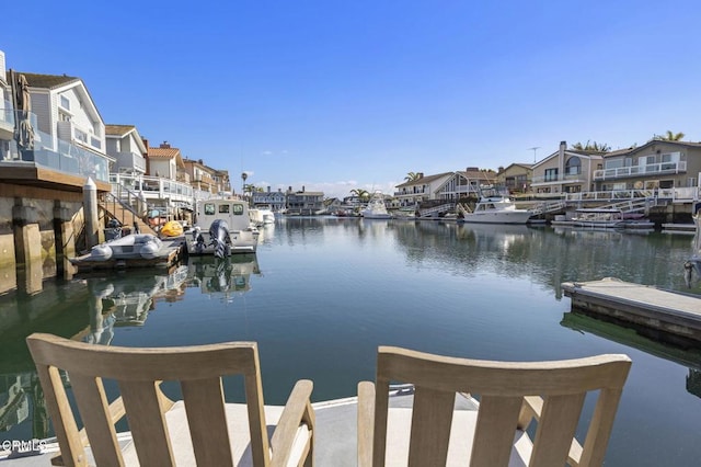 dock area with a residential view and a water view