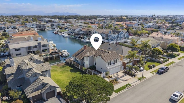 birds eye view of property featuring a water view and a residential view