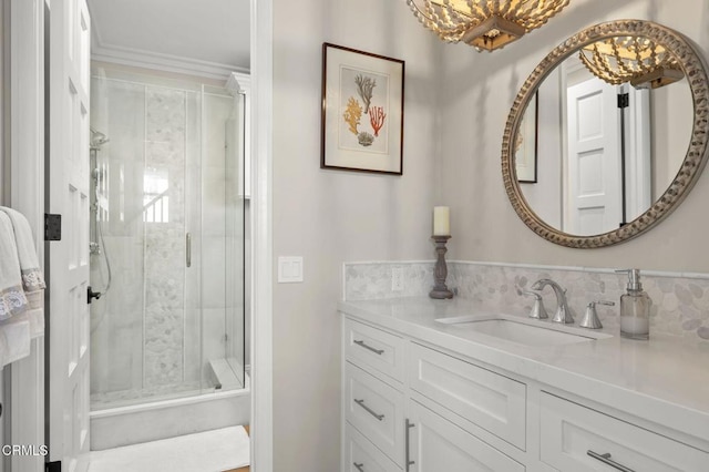 bathroom with a shower stall, crown molding, and vanity