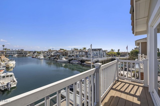 balcony featuring a water view and a residential view