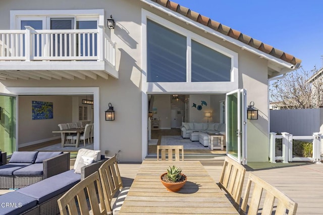 wooden terrace featuring an outdoor hangout area and outdoor dining space