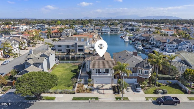 drone / aerial view with a residential view and a water view