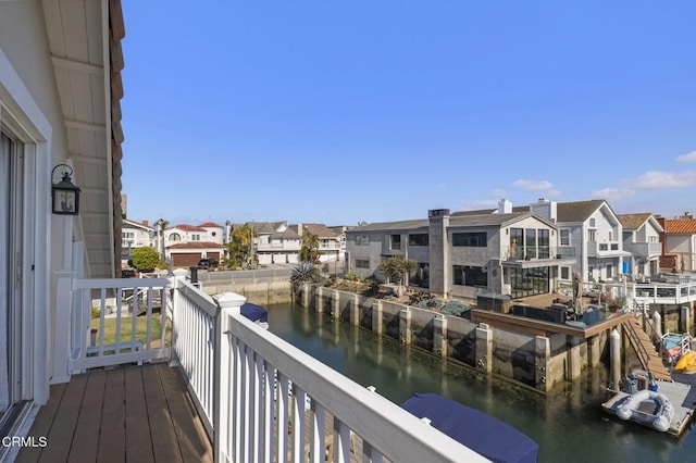 balcony featuring a water view and a residential view