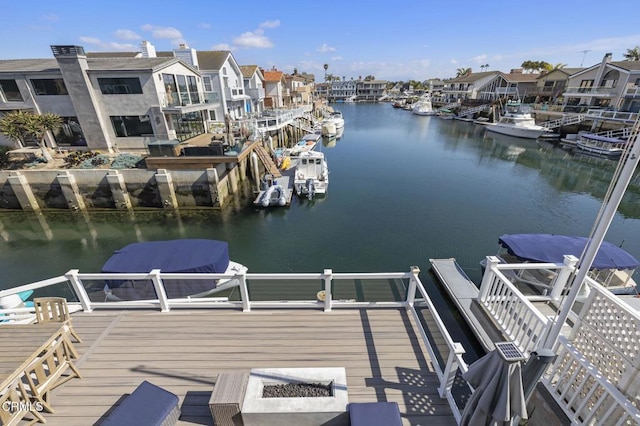 dock area featuring a water view and a residential view