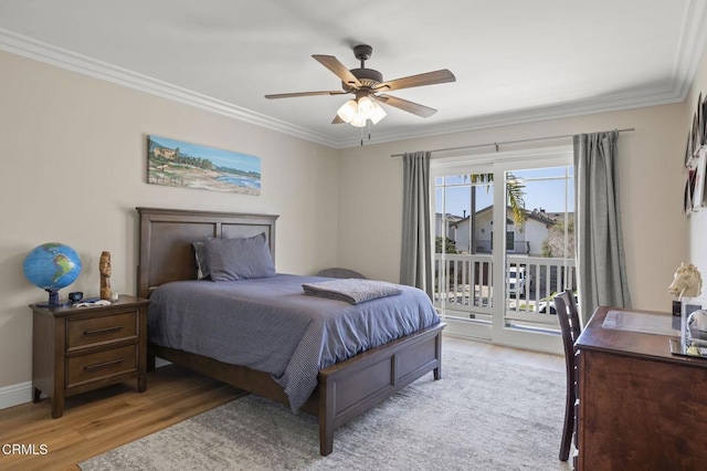 bedroom featuring baseboards, access to outside, ornamental molding, and wood finished floors