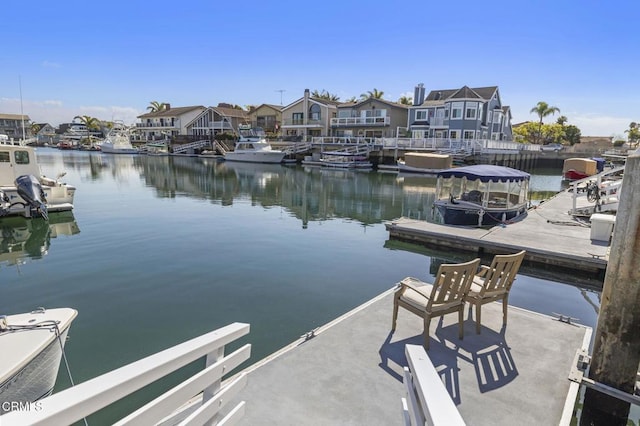 dock area featuring a water view and a residential view