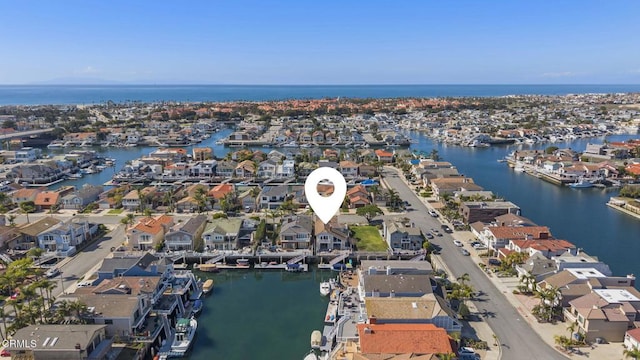 drone / aerial view featuring a water view and a residential view