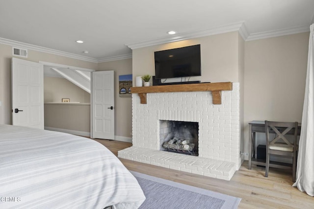 bedroom featuring baseboards, ornamental molding, visible vents, and light wood-style floors