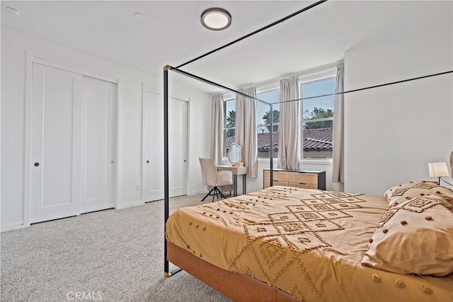 bedroom featuring light colored carpet