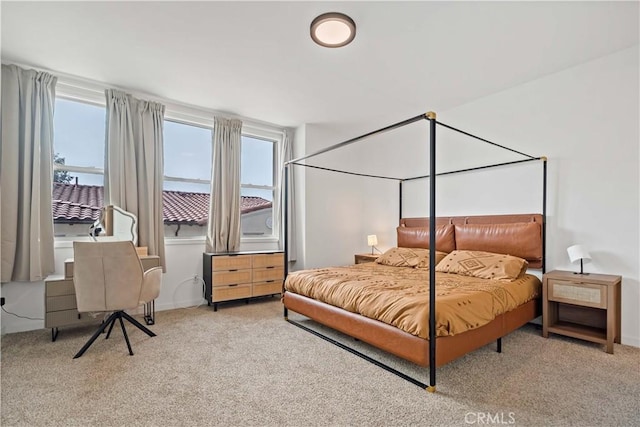 bedroom featuring light carpet