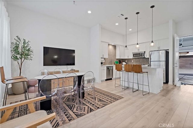 interior space featuring recessed lighting, visible vents, and light wood-style floors