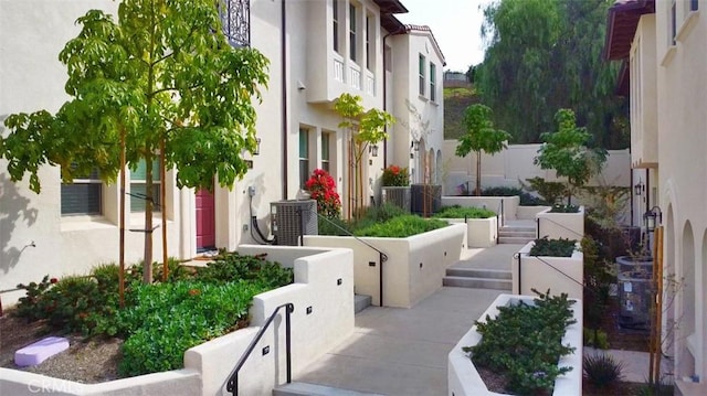 exterior space featuring central AC unit and fence