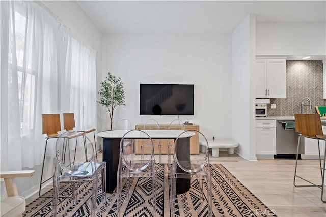 interior space with light wood-style flooring and baseboards