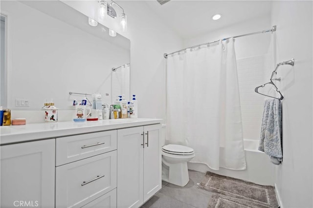 bathroom featuring shower / bath combination with curtain, tile patterned flooring, vanity, and toilet