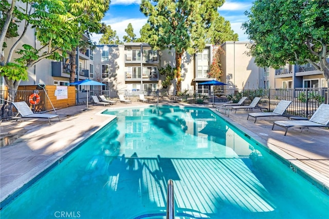 pool featuring a patio area and fence